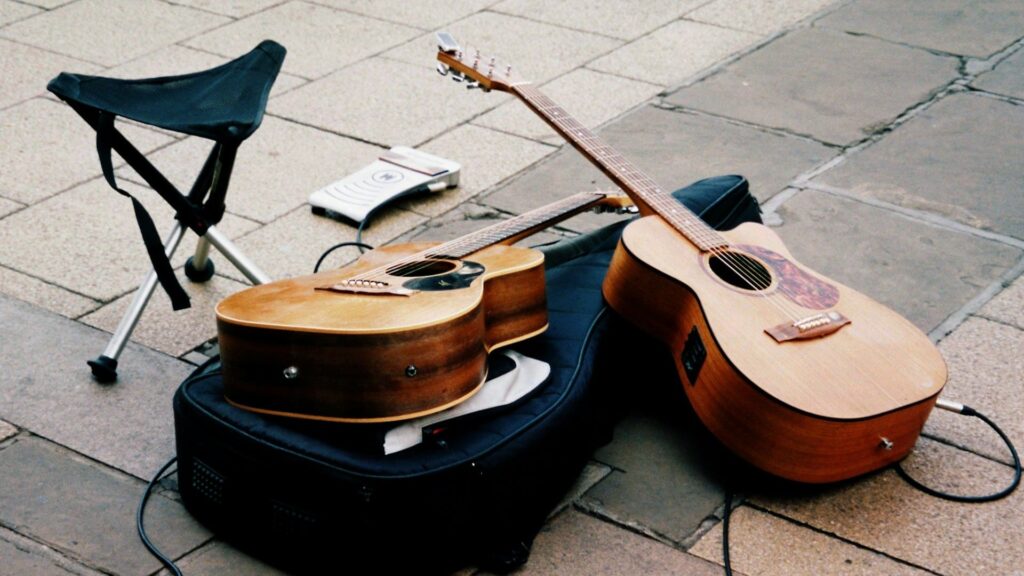 Straatoptredens met twee akoestische gitaren en versterker op straat